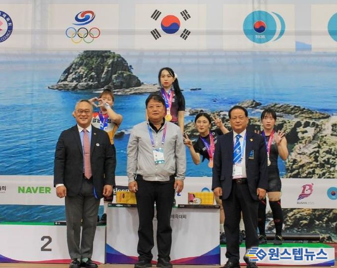 수상대에서 금메달을 걸고 선수들과 기념사진 찍는 신재경 선수(수상대 왼쪽 2번째)