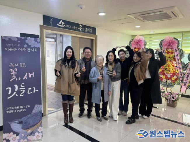 이동문 작가가 평촌동 소공갤러리 입구 앞에서 가족들과 함께 전시 기념 촬영을 가졌다